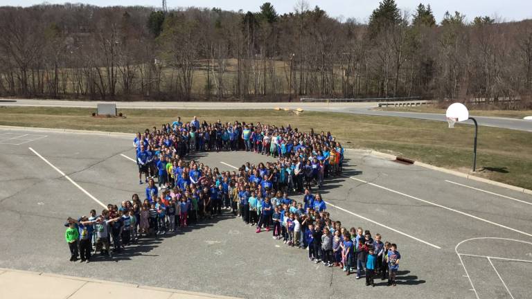 District 'lights it up blue' for autism awareness Westbrook school formed their own autism ribbon.