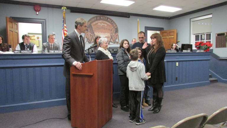 Township Council reorganizes with two new members, president Councilwoman Trisha Gerst, with her husband, children and mother gathered around her, take the oath of office.