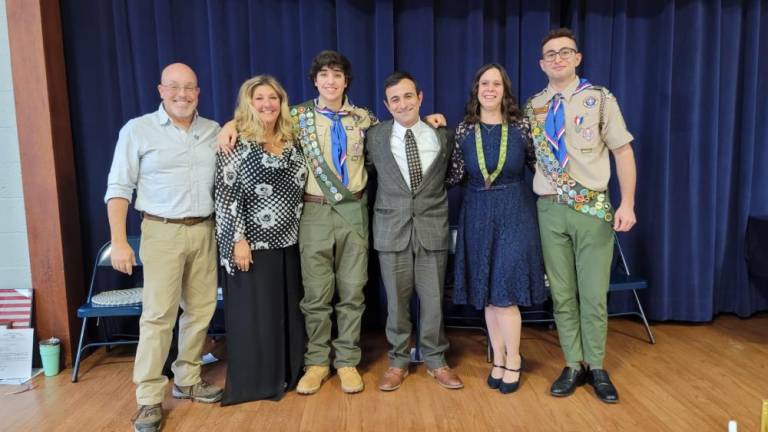 The new Eagle Scouts pose with their families.