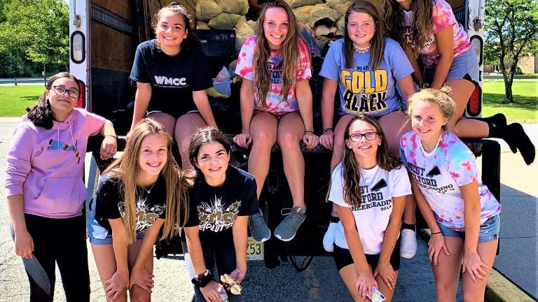 Cheerleaders gather 3,700 lbs of clothing during recent drive Cheerleaders gather 3,700 lbs of clothing during recent drive