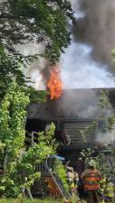 A fire burns a house at 51 Race Track Drive on Monday morning, May 15. (Photos by Brian P.. Fisher)