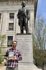 Dan Willever stands before a statue of the late U.S. Sen. William Hughes in front of the Passaic County Courthouse in Paterson. (Photo provided)