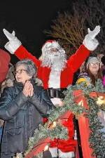 Santa Claus signals for the tree to be lit at last year’s tree lighting.
