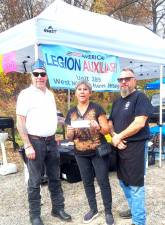 Ed ‘Tripp’ Grala and Frank Kostoplis, commander and first vice commander of the Sons of the American Legion, respectively, present a $1,500 check to Debbie Flowers, director of the Great Falls Rotary Foundation’s Military Assistance Pantry. The money was raised at the hamburger tent at the Harvest Festival on Oct. 28 at Bubbling Springs.