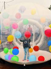 Fiona Crosser of Rockaway plays with balloons inside an inflatable Sunday, Sept. 29 at the Autumn Lights Festival in West Milford. (Photo by Maria Kovic)