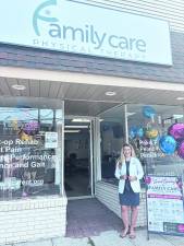 Dr. Nicole Mustafa poses in front of Family Care Physical Therapy.