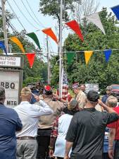 Members of West Milford Veterans of Foreign Wars (VFW) Post 7198 salute as flags are raised Sunday, Aug. 17 to commemorate the post’s new home in the former Upper Greenwood Lake Volunteer Ambulance Corps building, 814 Warwick Turnpike, Hewitt. (Photos by Fred Ashplant)