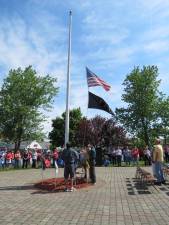Photos by Patricia Keller Flags are raised at the beginning of the Memorial Day ceremony on Monday.