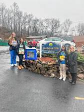 Passaic County Technical Institute students Aleksandra Szymanska, Angel DeLos Reyes and Fatihah Ahmed pose with one of the Little Free Libraries that they are donating to various locations. (Photo provided)