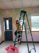 ART1 Ninth-grader Marie Swan works on the Peace Corner at the Highlander Academy. (Photo provided)
