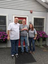 West Milford Animal Shelter Society president Paul Laycox, center, accepts a check for more than $2,000 from Kevin Goodsir, exalted ruler of West Milford Elks Lodge #2236, and fundraising coordinator Robin Logan, who organized a cornhole tournament to raise some of the money. (Photo provided)