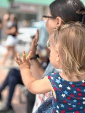Brayleigh Conklin and her mother, Chelsea, of Greenwood Lake wave at her father, a firefighter in the Celebrate America Parade on Saturday, July 5. (Photos by Denise von Wilke)