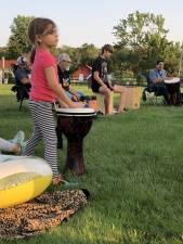 DC1 Residents from three generations joined the drum circle Tuesday evening, July 11 at the Wallisch Homestead in West Milford. (Photo by Kathy Shwiff)