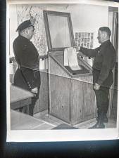 West Milford Police Chief John Moeller, left, and Capt. Jack Ryan check the teletype machine at Police Headquarters. which was in the balcony of the current West Milford Museum, in the early 1950s. (File photo by Ann Genader)