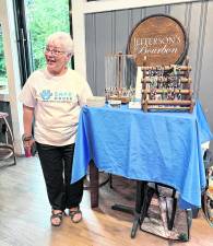 Nancy O’Tool from S.A.F.E. House animal rescue and sanctuary offers jewelry she makes for sale as part of the fundraiser.