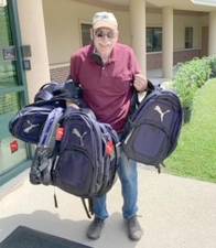 Tim Parker, Project Self-Sufficiency Leadership Council member, recently donated new backpacks to the agency (Photo provided)