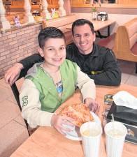 Det. Lundrim Veliu poses with Driton Mill.