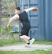 Tanner Christie throws the discus.