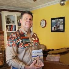 David Chamalian of West Milford holds a book that he wrote for his two sons, now in their 20s. (Photo by Rich Adamonis)