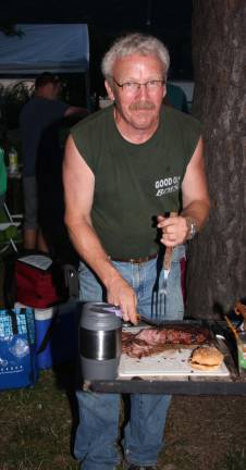Don Bender slices up a juicy London broil for dinner. Earlier in the day he was into more exotic vennison and elk entrees.