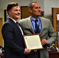 Macopin Middle School History Teacher Robert Callamari, left, holds up his plaque as Teacher of the Year with Schools Superintendent Alex Anemone during Tuesday night's Board of Education meeting. (Connor Murphy photo)