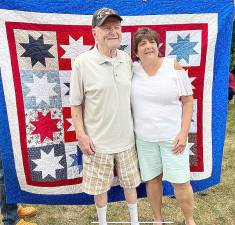 John McClellan stands with quilter Debbie Van Brunt, who hosted the event.