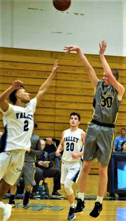 Josiah Basket, right, takes a shot while on his way to a career 1,000 points for West Milford.