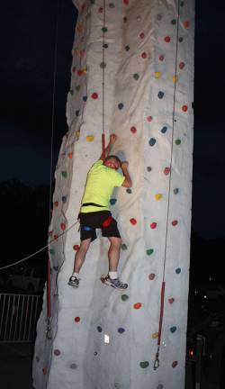 Volunteer Kurt Rifenbark shows how it's done on the rock climbing wall. Photo by Ginny Raue
