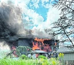 A structure fire burns at 2 Louis Ave.