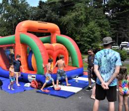 Children play on a huge blow-up obstacle course with a large bounce house. (Photos by Fred Ashplant)