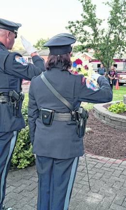 West Milford police officers salute a wreath in memory of the 9/11 victims.
