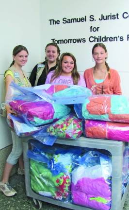 Girl Scouts, from left, Rachael Bakunas, Julia Kenyon, Marissa Munafo, and Ashley Driemel of troop 539 earned their Girl Scout Silver Award by making blanets for cancer patients. The girls raised the money and created the 40 blankets before delivering them to the patients themselves.