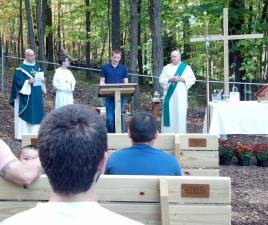 Eagle Scout Tom Buechel spoke at the outdoor chapel at St. Joseph Church. His project included additions to the chapel including benches, a lectern a cross and a concrete bench for the priest.