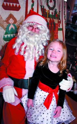 Sofia Hearon is one happy four year old as she perches on Santa's lapSaturday at the West Milford Museum.