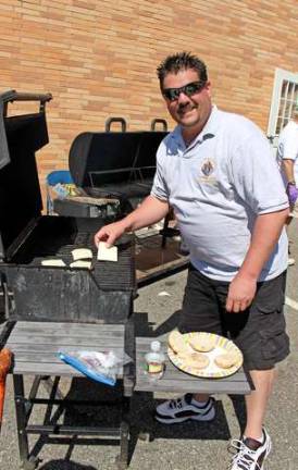 The Knights of Columbus manned the grills and kept the hot dogs and burgers coming full speed ahead. Mike Heller-Guidice, pictured here, gets those cheeseburgers ready.