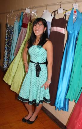 Danielle Burns, the president of West Milford High School Interact Club at the Cinderella Project dress sale on Sunday, Feb. 2. Burns and the club members collected 200 formal dresses to be sold at bargain basement prices. She managed to pick up one for herself, a pretty aqua polka dot dress that she's thinking about wearing for her June graduation.