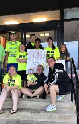 Kyle Lang takes a moment to pose with West Milford Special Olympic coaches and runners. photo by kristi clave