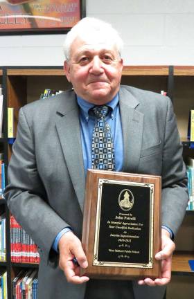 Interim Superintendent John Petrelli shows the plaque that was presented to him Tuesday night for his service to West Milford. He has led the district for nearly two years. New superintendent James McLaughlin begins July 1.