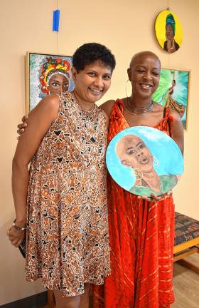 Sue Siva, left, with a friend who is a singer and the subject of her painting ‘The Song Bird.’