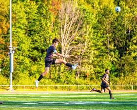 Senior Nick Bognar kicks his ball midair. (Photos by TJ Nolan)