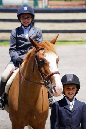 Devon, atop her pony 'Skys the Limit,&quot; is seen here with her brother Dylan, also a rider.