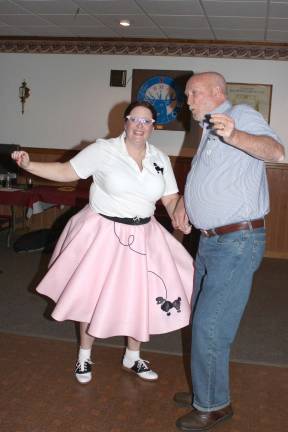 Community Services and Recreation Director, Jayme Mulhern in her poodle skirt, dances with her husband John.