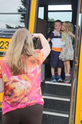 Amber Cantora gives her twin brother, Reilly, a hug as their mom takes that all-important first-day-of-kindergarten photo.
