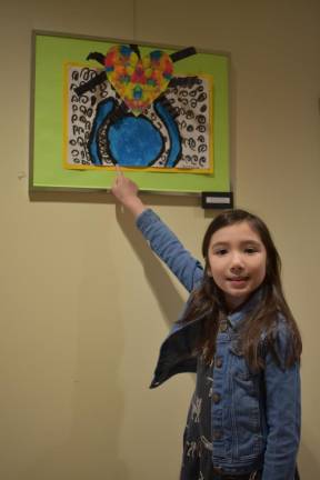 Veronica Gensheimer, 8, points out her colorful artwork.