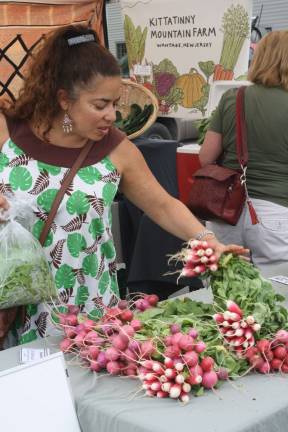 Photos by Linda Smith Hancharick Radishes, spinach and lettuce were some of the vegetables available at the West Milford Farmers Market on Wednesday. Kittatinny Mountain Farm had plenty of customers. It is a certified organic grower.