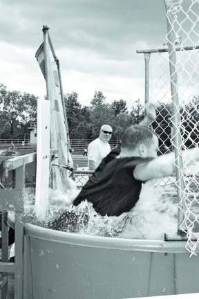 West Milford High School principal, Paul Gorski, is all wet inside the dunk tank. Photo by Ginny Raue