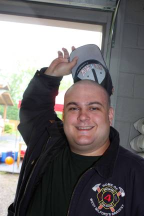 Volunteer firefighter with Co. #4, Andrew Blackwell, demonstrates hats off to going bald for the cause, in this case raising funds for childhood cancer research.