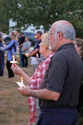 Residents stood with their candles dueing the solemn ceremony of honor and remembrance.