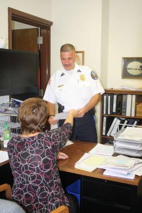 Photo by Linda Smith Hancharick West Milford's police Chief Timothy Storbeck, seen here with department assistant Dot WInk, took over the position on July 1. The transition, he said, was seamless.