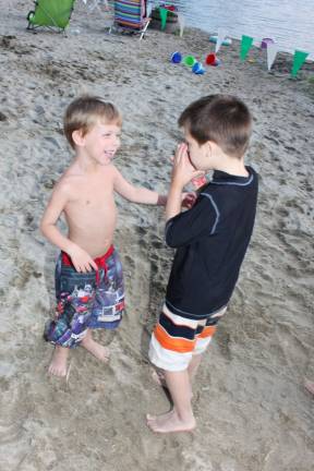 Chase Banda and Michael Ray have fun dancing on the beach at Pinecliff Lake Family Day event.